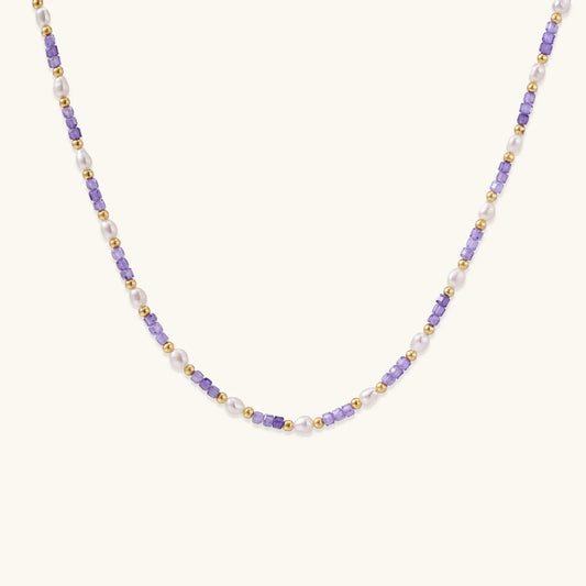 Delicate 18K gold vermeil necklace with alternating lavender zirconia beads and white freshwater pearls on cream background