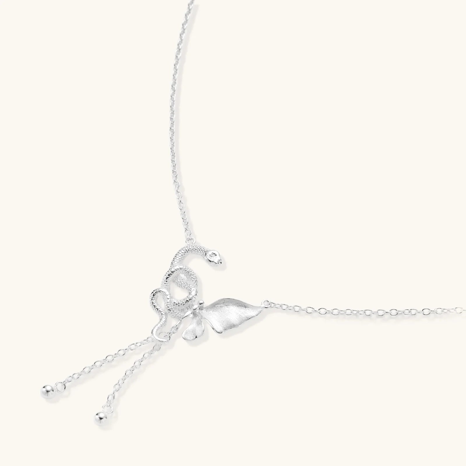 Sterling silver butterfly pendant with textured wing detail on adjustable Y-chain with ball drop ends