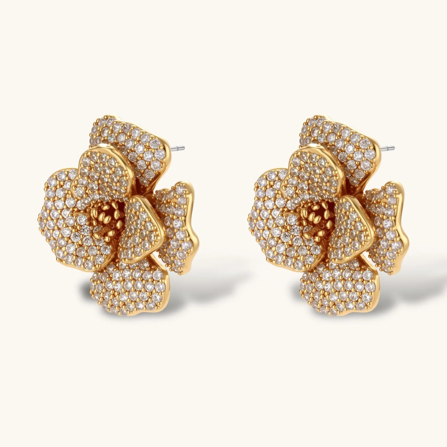 14K gold-plated floral jewelry set with blue cubic zirconia centers and pearl chain details on white background.