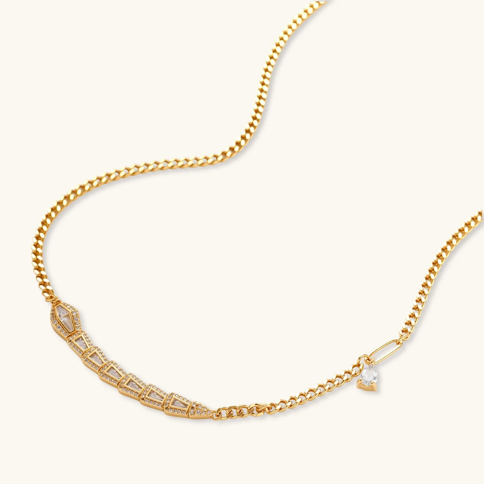 Gold-plated necklace with geometric diamond segments and matching huggie earrings featuring cubic zirconia details